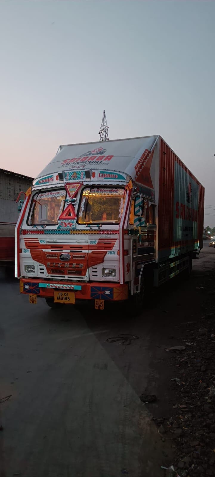 Saibaba Transport truck on the road at dusk